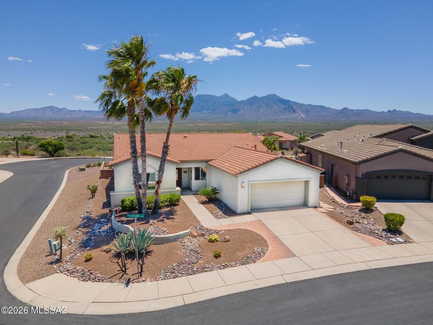 Discover refined desert living in this 1,775 sq ft 2-bed + den home on a premium ¼-acre lot with unobstructed mountain and valley views. Enjoy a light, open layout with tile floors, custom paint,  cherry cabinets, Silestone counters, roll-outs with newer range, refrigerator, dishwasher, and washer. The den features built-ins and a coffered ceiling; the owner's suite offers a bay window and upgraded primary bath. Wait till you see the shower! Extended laundry/hobby room and oversized garage with workbench, storage, and cedar closet. Outdoors, relax under the covered patio pergola and upgraded paver patio, with thr peaceful waterfall, ideal for entertaining with stunning views. Located in a quiet, well-loved 55+ Green Valley community with full GVR amenities nearby.
