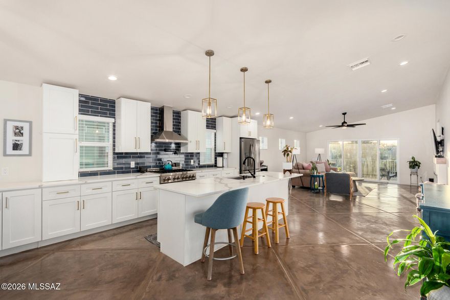 Seller to counter or accept offers between $469,000-$485,000. Exceptional 2021-Built Contemporary Home offering DESIGNER FINISHES, Flexible Floor Plan, and ICONIC TUCSON SUNSETS. This well thought out home features 3 BEDROOMS, 2 BATHS, plus a versatile DEN/OFFICE that can easily convert to a 4TH BEDROOM. Designed with a desirable SPLIT-FLOORPLAN, STAMPED CONCRETE FLOORS, abundant natural light, and a CHEF-INSPIRED KITCHEN with 36 IN. GAS RANGE and MASSIVE ISLAND. DESIGNER TILE, QUARTZ COUNTERS, and EXTENSIVE CUSTOM CABINETRY throughout. Enjoy a BUILT-IN GAS FIREPLACE, spacious PRIMARY SUITE with WALK-IN CLOSET, and SPA-LIKE BATH with WALK-IN SHOWER. Includes loop for whole-home water filtration system. WEST-FACING EXTENDED COVERED PORCH for stunning Tucson sunsets. Move in ready  & NO HOA!