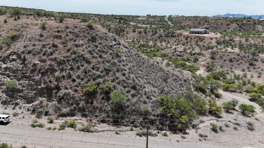 Build your home on a hilltop without having to climb the hill.  This lot has fairly level access that leads out to the end of a bluff with stunning views. I saw a metal box at the end of the street which tells me there is a water line and there are also power poles at the street.