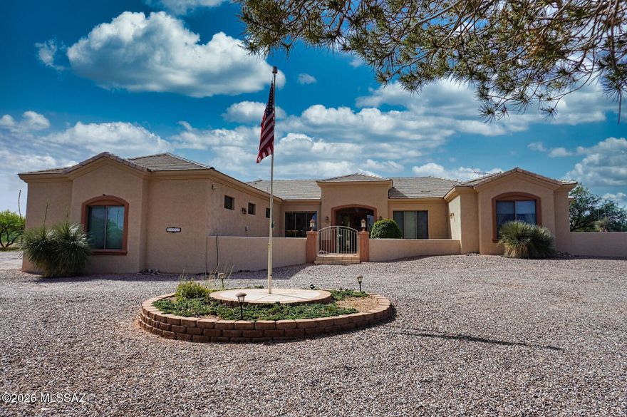 Perched high on a scenic Elevated 10 acre parcel in Benson, this meticulously maintained Modern Santa Fe style home backs up to State Land on 2 sides! This property offers an exceptional blend of privacy, quality construction, and breathtaking Panoramic and Mountain views. The property is fully fenced and gated with a long, private  and paved driveway leading to a truly special retreat. 
Step inside to find a welcoming foyer, large great room, wood burning fireplace, lots of windows,  a neutral color pallet and vaulted ceilings. The home is constructed from insulated concrete ''Rastra Block''  and is finished with a durable stucco exterior and ceramic tile roof, this home is designed for lasting comfort and efficiency. Outside there are large covered patios facing both east and south-idea for enjoying vibrant sunrises, cool shaded afternoons, and peaceful desert evenings. The patios have been upgraded with a professional epoxy textured coating, adding both beauty and durability to your outdoor living spaces. 
Equestrian enthusiasts will appreciate the horse facilities including tack and feed room, horse shelter for 2 and direct access to adjacent state land, complete with a private gate--offering endless opportunities for riding and exploring right from your own property!
Additional highlights include an oversized two-car garage, Plus a third detached workshop/garage, meticulous upkeep home throughout, and a setting that delivers unmatched tranquility, space, and wide-open skies. Home has a private well with excellent drinking taste without being filtered. 
If you're seeking privacy, views, access to state land and the ultimate Arizona lifestyle, this one-of-a-kind property is not to be missed!