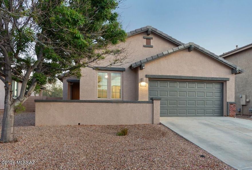 This home features several recent upgrades, including fresh exterior paint, a new HVAC unit installed in December 2025 and upgraded stainless steel appliances. The interior offers a kitchen with upgraded 42 inch cabinets and granite countertops. Split bedroom floor plan with a private primary bedroom, 20-inch tile in the living areas, upgraded carpet in the bedrooms and a Jack and Jill bathroom for the 3 other bedrooms. Outside, the backyard includes an extended paver patio with a built-in fire pit surrounded by a turf area, and backs up to a greenbelt with no direct rear neighbors for added privacy. Community pool. Located in the Vail School District.