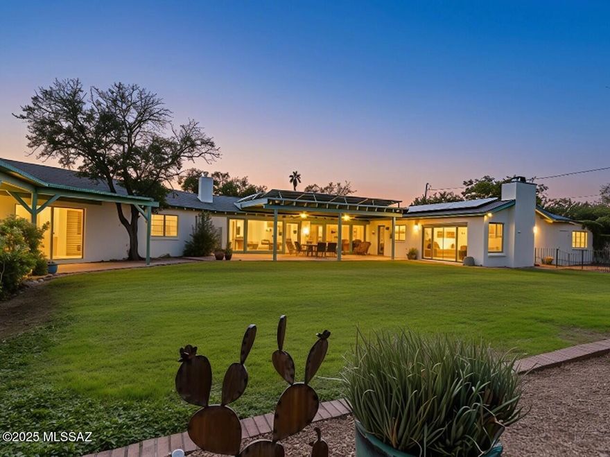 This sprawling historic ranch home in Catalina Vista is available after four decades in loving stewardship. Brick construction, a premium corner lot, registered private well, and owned solar make this a spectacularly desirable property. Elegant finishes and enchanting exterior spaces harken to the neighborhood's stylish landmark, the Arizona Inn. Expansive cabinetry in the gourmet kitchen and 48 inch sub-zero refrigerator are uncommon for a home built in 1953. Island seating, stone countertops, and built in breakfast nook open to the family room with gas fireplace and doors to both the backyard and secondary courtyard. The gracious living & dining room has floor to ceiling windows and sliding doors with views of the Catalina Mountains and the expansive mature lawn. The primary suite offers a substantial walk-in closet, updated bathroom, and sliding glass doors overlooking the pool and patios. Two additional bedrooms, a den/office, well equipped gym, and spacious laundry room complete this extraordinary property. An oversized two car garage, sensitive updates, and over a half acre lot make this home a rare and remarkable cornerstone of our historic central Tucson community.