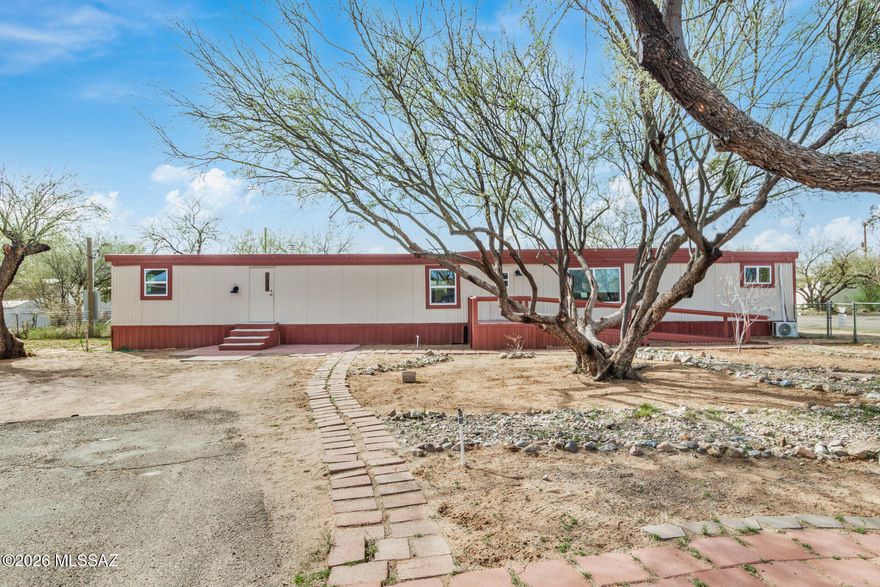 Light-filled 3-bedroom, 2-bath manufactured home in the peaceful Santa Rita Heights Mobile Home Park on leasehold land. The thoughtful split floorplan offers privacy and a generous living area drenched in natural light. The kitchen provides ample cabinetry and flows to the dining area for easy everyday living. Primary suite with a private bath; all bedrooms are well-sized. Outdoors features low-maintenance desert landscaping, mountain views, and a front entry ramp for added accessibility. Parking includes a dedicated space on the north side plus a multi-vehicle driveway. Well cared for with recent updates throughout and move-in ready.