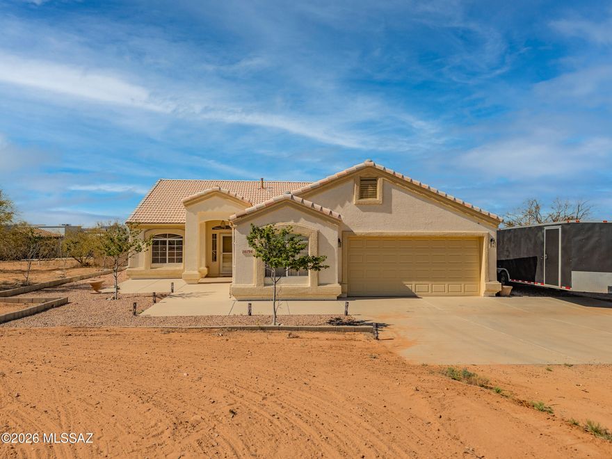 Enjoy stunning Arizona sunsets and mountain views from this unique property featuring 2.6 total acres across two parcels sold together as one. Sale includes the home site plus the adjacent 1.26-acre parcel immediately to the east (Tax Code 301-67-3110).
Inside, the home offers an immaculate kitchen with ample cabinetry, stainless steel appliances, granite countertops, and Mexican tile backsplash. The breakfast area features a bay window, and the center island with breakfast bar adds extra prep and seating space. The primary suite includes a wall niche, dual sinks, and a walk-in closet, while the guest bath has been upgraded with dual sinks. Outside, the cement block-fenced backyard is ready for entertaining. An oversized garage provides plenty of room for storage or toys, and the electrically wired shed offers added flexibility.