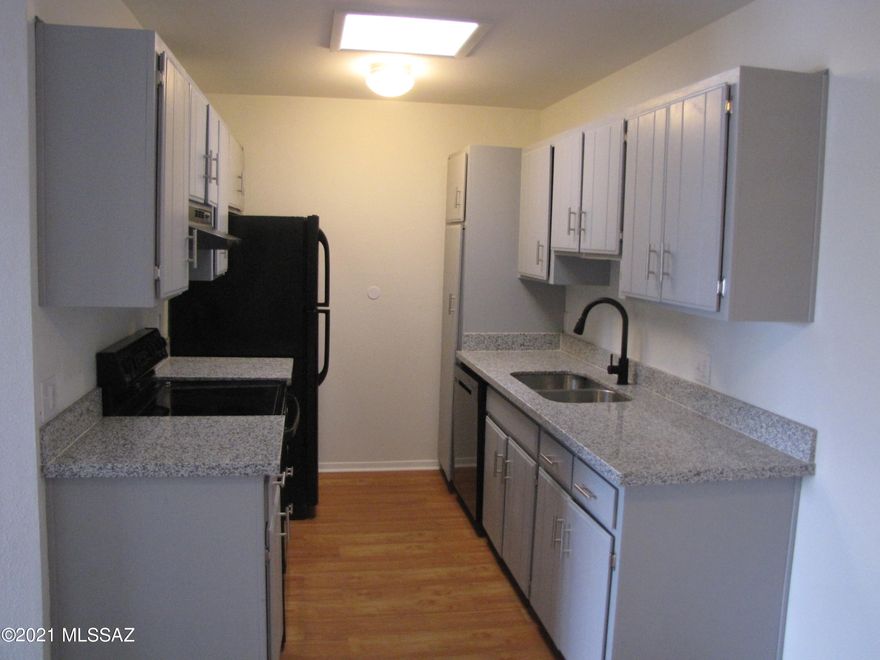 Tastefully remodeled Townhouse with a Community Pool!  Spacious open floor plan.  Freah paint. Ceiling fans, window blinds & handsome engineered wood floors.  Stunning new kitchen features granite counters, under-mount sink, pantry, newer appliances & plenty of gray cabinets w/stylish hardware.  This move in ready charming home boasts 2 large bedrooms, ample closets, 2 upgraded baths with granite counters, & private balcony.  Interior laundry closet for your convenience