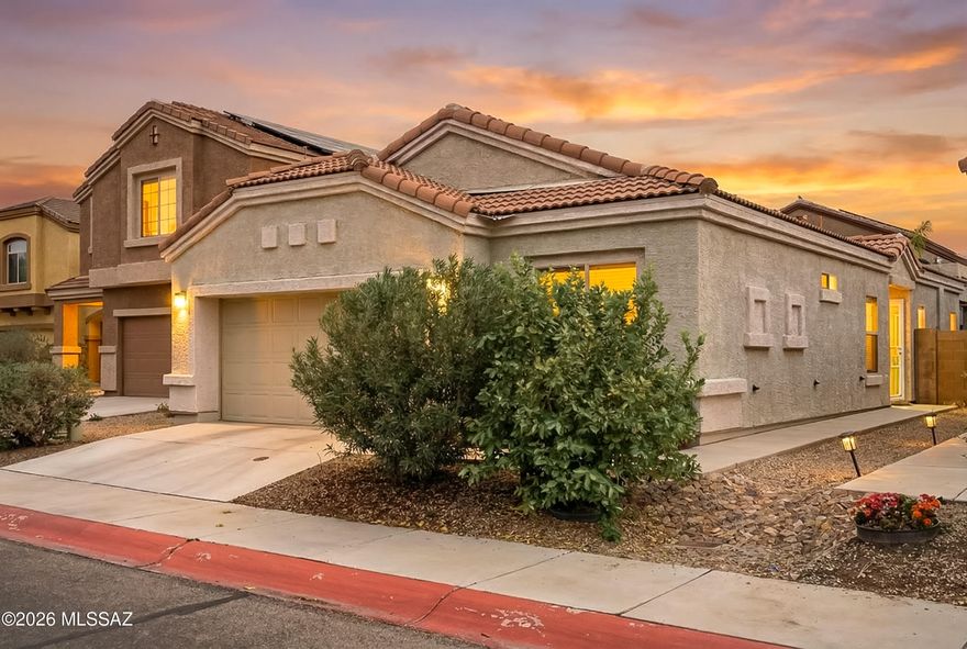 Located in a gated Marana community, this thoughtfully maintained home offers a functional layout, modern finishes, and access to neighborhood amenities including a community pool, play area, and sidewalks.
The home features three bedrooms, two bathrooms, and a dedicated den, providing flexible space for a home office, hobby room, or additional living area. High ceilings and a split-bedroom floor plan create an open feel while maintaining privacy between the primary suite and guest rooms. The kitchen includes granite countertops, stainless steel appliances, and contemporary cabinetry, opening comfortably to the main living space. No carpet throughout adds a clean, low-maintenance touch.
The primary suite includes a walk-in closet and an en suite bathroom with dual sinks and ample storage Outdoor living is a standout feature. The impeccably maintained backyard includes turf and mature vegetation, along with a covered porch and additional ramada that conveys, creating multiple shaded areas for relaxing or entertaining.
Conveniently located just minutes from Cortaro Farms shopping, nearby golf, and highly rated schools, this home combines comfortable living with easy access to everyday amenities in one of Marana's most convenient areas.