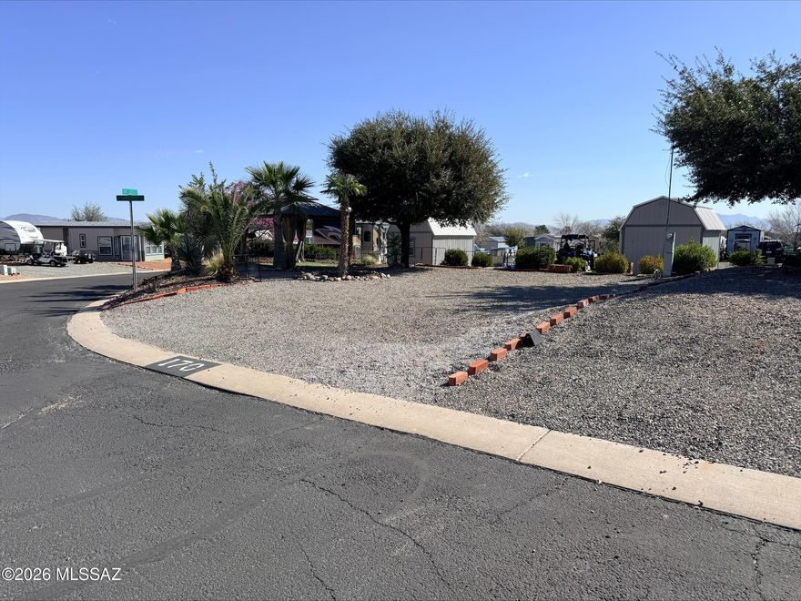 Exceptional corner lot available in a highly desirable RV resort community. Surrounded by beautifully maintained landscaping with a gazebo set up, this site easily accommodates a large RV and provides ample room to enjoy outdoor living. Resort amenities include a pool, spa, fitness center, paved streets and a dog park., creating the perfect setting for comfortable and active resort living.