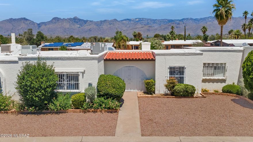 Quiet, easy living in the highly desirable,  Desert Palm Townhouses with low HOA fees. This charming townhouse is a must see for buyers seeking a primary home or a lock and leave second home. Private courtyard entry, oversized 2-car garage, and three good sized bedrooms with two baths offer comfortable, flexible living. And a bonus of no carpet and a 3-year old HVAC system. The primary bath has been thoughtfully updated with a walk in shower. Light filled spaces, skylights, and a cozy brick, gas fireplace create a warm, inviting feel. The private walled rear yard with covered patio is ideal for relaxing or entertaining, or just smelling the roses, literally. Community pool just steps away and a convenient eastside location close to shopping, dining, parks, and everyday essentials.