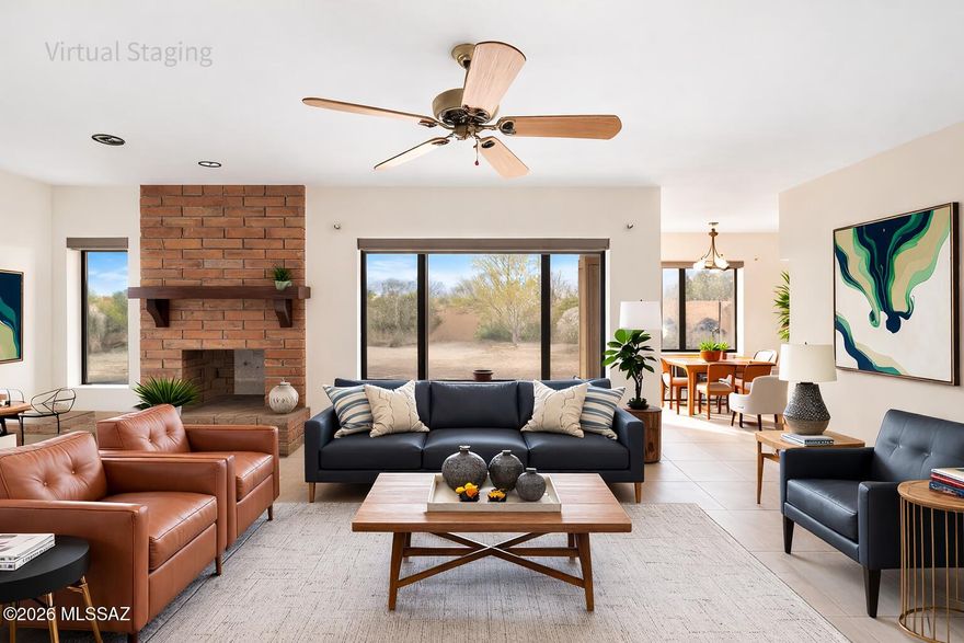 Set on over 3 beautiful acres, this exceptional home offers a rare combination of privacy, breathtaking mountain views, and timeless Southwestern character. Surrounded by natural desert landscape and located in a quiet, peaceful neighborhood, the property captures the beauty of Southern Arizona living while still being conveniently close to shopping, dining, and everyday amenities.
Inside, the home welcomes you with bright, open living spaces filled with natural light and warm architectural details that blend Southwestern charm with modern style. The spacious living room is anchored by a stunning brick fireplace, creating a cozy and inviting focal point perfect for relaxing evenings or gathering with family and friends. Large windows throughout the home frame the surrounding desert