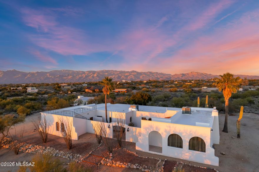 Spanish-style desert estate with business opportunity plus! Two-Bird Ranch, as this home was once named, has some historical significance. A profitable short term rental, 85% occupancy rate with 5 star ratings & many repeat groups of travelers. Property sits on 4.5 acres with sweeping views in every direction. Charm of the southwest in both construction & decor extraordinaire (beams, Kiva Beehive F.P., scored concrete floors & mexican tile accents). The charming courtyard, with fountain, greets your visitors. The incredible guesthouse/studio offers even more variety of choices with this 5 bedroom/4 bth main house. Resort-style outdoor areas to relax & play. Located near Saguaro National Park with biking & horse trails nearby. Rooftop deck for star gazing & sunset/mountain viewing.