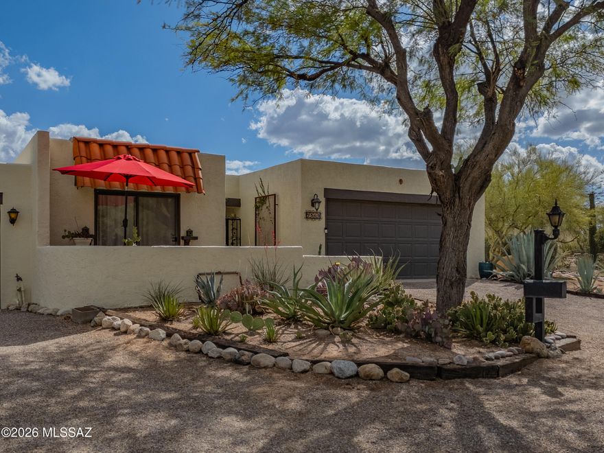 Desirable end-unit patio home located in the sought-after Westward Look enclave, offering stunning mountain views from the north-facing front patio and peaceful desert/natural landscaping from the rear covered patio. Enclosed courtyard entry provides added privacy and charm, with substantial solid wood double front doors opening to an elegant formal foyer. Ideally positioned with an offset design, the only shared wall is with the neighbor's garage--enhancing privacy and quiet living. Light and bright throughout, the home features an efficient, well-designed floor plan with a spacious living area highlighted by a cozy gas fireplace and a sizable dining area overlooking the private courtyard--ideal for everyday living and entertaining. The charming kitchen includes an inviting eat-in nook with mountain views and generous pantry storage. Both bedrooms are over-sized, with the primary retreat offering direct access to the back covered patio, and the guest bedroom overlooking the courtyard with convenient access to an adjacent bathroom. End-unit location allows for added privacy along with nearby extra guest parking. A tranquil desert retreat with seamless indoor-outdoor living.  Close to shopping, dining and hiking trails!  Welcome Home!  Professional photos to be published on 5/8.