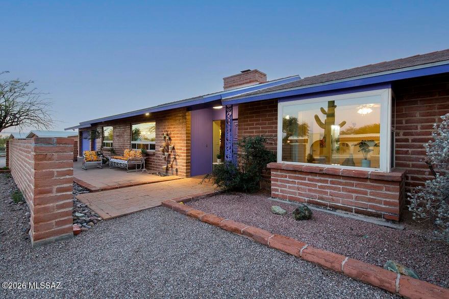 Gorgeous spacious adobe brick home on nearly an acre with sparkling pool, and a huge walled backyard overlooking the Tucson mountains to the west. Sunsets will be yours every night!   Kitchen remodel is stunning featuring a huge custom wood island, custom  soft-close cabinetry. Stainless appliances, built-in wine fridge... a kitchen designed for entertaining! Wood-burning double sided fireplace makes a cozy focal point for both living room areas. Interior of home is freshly painted. Bathrooms are both remodeled; this home is beautifully maintained & move-in ready. Two car garage has storage room, laundry room opens to backyard and garage. Place for an RV. The two back porches span the entire home, and the property extends beyond the back wall with natural desert.  Completely reroofed!