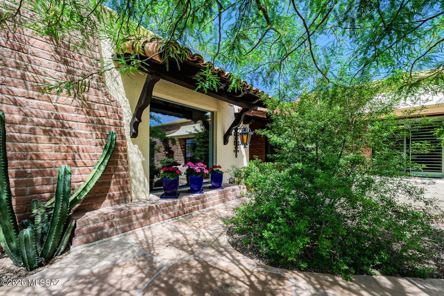 This tasteful, total remodel of a classic Tucson burnt-adobe territorial townhome is in the highly sought-after Catalina Pueblo community in the heart of the Catalina Foothills. The residence is privately situated next to 1 of 3 community pools, away from traffic noise, yet close to La Encantada Mall, restaurants, art galleries, and shopping. Rich w/Spanish & Mexican design accents, this charming 2084 sq. ft. home offers 3 bedrooms + a living room, formal dining, a family room, & a library/den. On the patio, a circular staircase leads to a rooftop deck w/sweeping city & mountain views. The inviting side porch w/flagstone pavers, natural gas hookups for a firepit & outdoor BBQ intertwine w/exceptional landscaping including faux grass, boulders & integrated lighting, a private gate to... the Caballo pool, & the right ambience for comfortable living & entertaining. Two natural gas wood-burning fireplaces present in the breakfast area/family room and library/den all opening seamlessly to the covered patio along the Caballo pool. Light & bright, the remodeled kitchen offers granite countertops, stainless steel, & custom appliances. The large laundry room has a walk-in pantry, addtl storage closet, & custom cabinetry. The family room/breakfast area boasts high beam ceilings w/corbels & a large picture window to the front garden. The primary suite w/French doors to the covered patio, includes 2 separate walk-in closets, a designer bathroom w/a dressing vanity & sink, & a pedestal sink in the shower/toilet room. The office/third bedroom showcases custom-built-in cabinetry & shelving. The oversized 2-car garage provides abundant storage options with workshop bench/storage. Property may not be purchased as a rental.