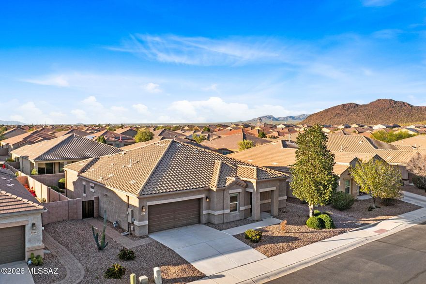 Welcome to effortless desert living in the 55+ gated community of Saguaro Bloom. This beautifully maintained 2-bedroom +den/3rd bed, 2.5-bath home blends thoughtful design with low-maintenance comfort ideal for full-time residents or seasonal retreat seekers. At the center of the home, a stunning chef's kitchen anchors the open-concept great room. Granite countertops, stainless steel appliances, a gas range, extended cabinetry, walk-in pantry, reverse osmosis system, and an oversized island create the perfect space for entertaining or everyday living. The split-bedroom layout offers exceptional privacy, with both bedrooms featuring en-suite baths and generous closet space. The versatile den complete with its own closet -- easily functions as a third bedroom, office, or hobby space. The primary suite provides a peaceful escape and includes direct access to the laundry room, pre-plumbed for a sink, adding everyday convenience to thoughtful design.
Out back, your extended paver patio and professionally landscaped yard create a private outdoor retreat. Enjoy morning coffee, sunset conversations, or relaxed evenings under Arizona skies in a setting designed for both tranquility and connection.
Saguaro Bloom offers a vibrant lifestyle with resort-style amenities including pools, splash pad, fitness center, bocce courts, clubhouse, parks, and scenic walking and biking trails. Just minutes from I-10 and Tucson Premium Outlets as well as shopping, this home combines accessibility with community charm. Move-in ready and designed for easy living -- this is the desert lifestyle you've been waiting for.