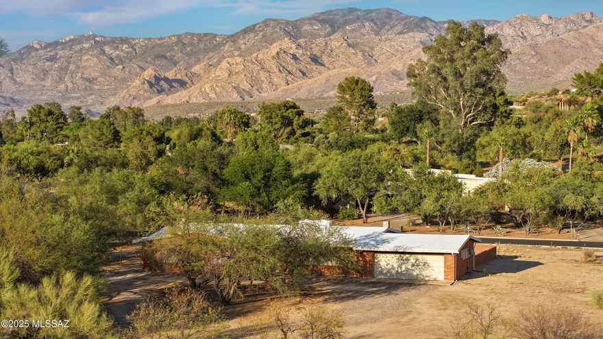 Own a Legacy in Oro Valley!  Step into a rare piece of Arizona history with the final remaining 4.68 acres of the original 640-acre ''Moon Glow Ranch'' family homestead.  Nestled in the prestigious Oro Valley Country Club community, this 1960 adobe brick ranch-style home offers 2,094 square feet, including three bedrooms, two bathrooms, Arizona room, and a 2-car garage. While the home remains in its original condition & will require a bit of TLC, its potential is undeniable.  From the front door to every corner of the property, take in sweeping Catalina Mountain views, stunning sunsets, & the serene beauty of the desert landscape.  With the potential to rezone, the land presents a rare investment opportunity or the chance to create a multi-generational estate.  Whether you're inspired to preserve a historic homestead or bring new life to a treasured site, this is a truly unmatched opportunity in Oro Valley.  Embrace the pioneering spirit of Southern Arizona and make Moon Glow Ranch your own.