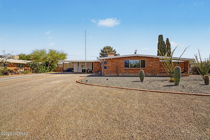 Fall in love with this brick-style home tucked in a quiet cul-de-sac! A combination of a gravel & paved driveway leads to convenient 2-carport parking, while the low-maintenance desert landscape enhances the home's curb appeal. Delightful interior welcomes you with a living room featuring a cozy wood-burning fireplace. Continue into the eat-in kitchen showcasing a breakfast bar island, a plethora of crisp white cabinets, SS appliances & granite counters. The main bedroom has direct backyard access, a dedicated makeup vanity, a private bathroom & a walk-in closet. A secondary bedroom offers its own direct access to the Arizona room! The Arizona room is ideal for year-round enjoyment. Generously sized backyard boasts a blank canvas, rear RV gate, & paved seating area. Don't miss it!