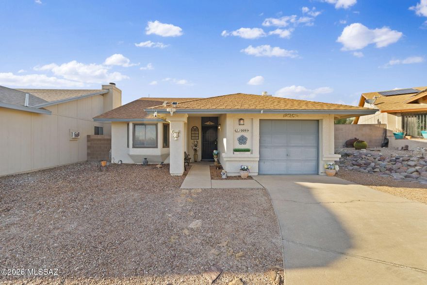 Welcome home to this charming East Tucson gem! This 2 bedroom, 2 bathroom home offers a comfortable layout with vaulted ceilings, great natural light, and a cozy living room fireplace that makes the space feel warm and inviting. The kitchen flows nicely into the dining area and provides direct access to the backyard, making indoor and outdoor living easy. Step outside to a private, low maintenance backyard with pavers, a covered patio, storage shed, and plenty of space to unwind or entertain. With a 1 car garage, extended driveway, easy care exterior, and a convenient Tucson location near everyday amenities, this home is a great fit for buyers looking for comfort, simplicity, and value.