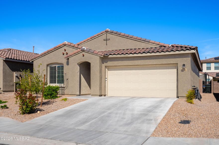Elegant, low-maintenance living awaits! Welcome to this beautifully maintained 3-bedroom, 2-bath home in the highly desirable Saguaro Trails community, where comfort, style, and flexibility come together. Designed with today's lifestyle in mind, this thoughtfully designed layout offers spacious bedrooms and versatile living areas to fit your evolving needs.

At the heart of the home is a bright, open-concept living space anchored by a stunning granite kitchen with upgraded cabinetry, generous counter space, and a large island perfect for entertaining, meal prep, or casual gatherings. Upgraded tile flooring and modern finishes throughout create a clean, cohesive look that feels both inviting and elevated. The tandem 2-car garage is a standout feature, offering exceptional functionality along with a modified attic for additional storage--ideal for seasonal décor, hobbies, or outdoor gear. Step outside to a low-maintenance backyard designed for easy living, whether you're enjoying your morning coffee or relaxing under Arizona's beautiful sunsets.

Located just minutes from scenic trails, neighborhood parks, and resort-style amenities including a pool, clubhouse, and sports courts, this home delivers the best of Tucson living in a community known for its beauty and convenience. A perfect opportunity for those seeking quality, space, and lifestyle in one of the area's most sought-after neighborhoods.
