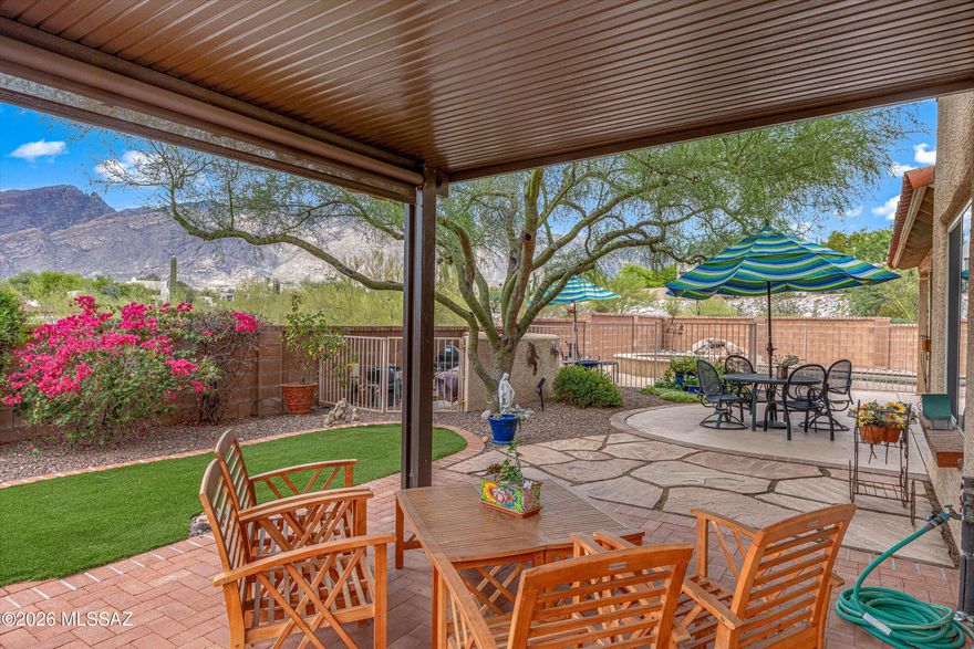 Nestled in a highly sought-after Catalina Foothills neighborhood, this beautifully maintained home captures breathtaking Catalina Mountain views, including iconic Finger Rock, along with stunning panoramic vistas that create an unforgettable Tucson backdrop.

Designed for comfortable desert living, the backyard feels like a private retreat with a pebble-tec pool and spa, waterfall feature, mature landscaping, expansive covered patio spaces, and a newly added pergola perfect for relaxing or entertaining year-round.

Inside, the home offers spacious single-level living with easy-care 18'' ceramic tile throughout, abundant natural light, and thoughtful accessibility features including widened hallways, doors, and a generously sized walk-in shower in the primary suite. Double doors from the oversized primary bedroom open directly to the backyard oasis, while dual walk-in closets provide exceptional storage.

The kitchen features upgraded appliances, ample workspace, generous cabinetry, breakfast bar seating, and a cheerful breakfast nook with views of the surrounding landscape. The adjacent living and dining spaces showcase the mountain views and include a cozy gas fireplace.

Additional highlights include:

Quiet office/den ideal for working from home or flex space
Epoxy-coated garage flooring
Central vacuum system
Water softener
Hot water circulator to the showers
Mini-Split A/C unit installed in the primary bedroom

Located just moments from premier Foothills dining, shopping, galleries, hiking, and top-rated schools including Catalina Foothills High School, this home combines peaceful desert beauty with everyday convenience.