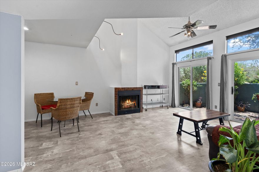 Soaring ceilings, skylights, and mountain views from every bedroom--this 3 bedroom + loft townhome is anything but ordinary. With a newer HVAC (2024), roof (2025), water heater (2025), fresh interior paint (2025), double pane windows and sliders, and a transferable termite warranty--plus fiber optic internet--you get peace of mind and performance. Inside: hardwood floors (no carpet), granite counters + stainless steel appliances, jetted tub, wood-burning fireplace, extended loft with wet bar, and tons of natural light. Enjoy a private patio, 2-car garage, 2 large walk-in closets, and the community pool/spa nearby. Plus extra parking in the back and no rear neighbors. Close to the UA and walking distance to the Tucson Racquet Club and the Loop!