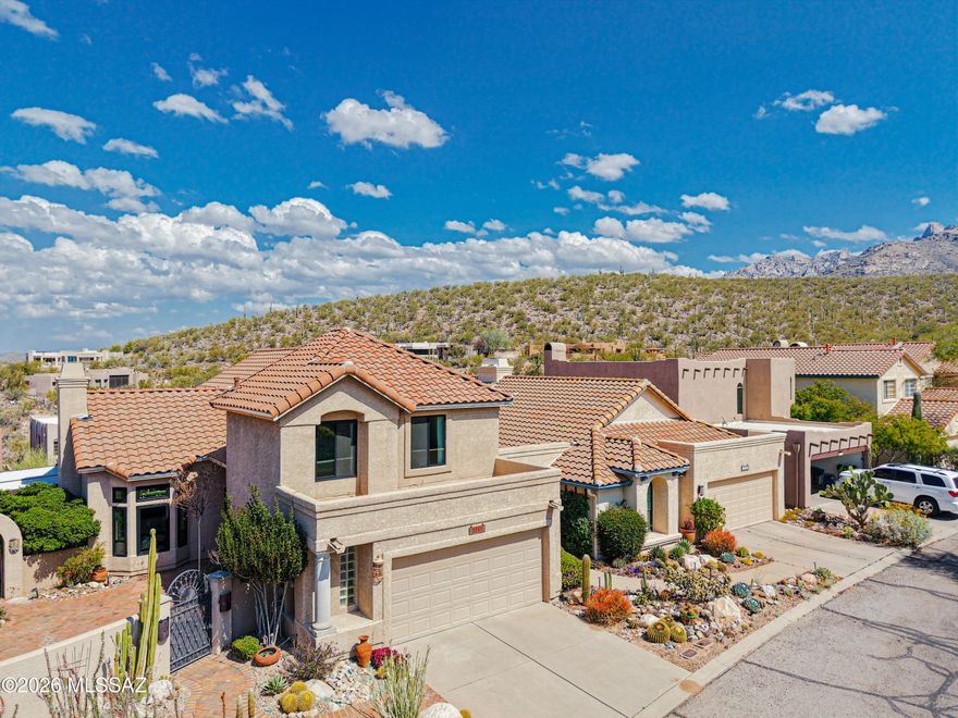 Sleek & sophisticated meets charming & cozy in this 1,979 sq. ft. contemporary home in the prestigious, gated community of La Reserve. Inside you'll be enamored with the vaulted ceilings, luxurious granite & quartz slab countertops, a stylish herringbone patterned luxury vinyl floor, and refined bathroom finishes. The blend of upscale materials & elegant style work seamlessly to create an stunning home in every sense. Layer this on top of elevated city & mountain views from the backyard & deck areas, all while surrounded by gorgeous lush landscaping. Enjoy added privacy with no rear neighbors too! Dual screened in patio areas & a backyard pergola make it a premier outdoor space. A stunning front paver courtyard w/fountain tops it all off. Upgraded Milgard windows & new roof in 2024. The living spaces provide flexibility with a formal living room that's centered around a majestic fireplace with granite slab accents and built-in dry bar area. Across the hall is a powder room with modern flair, all the while enjoying views onto the front courtyard. A formal dining room provides plenty of seating for meals, with an doorway leading onto one of the two screened-in patio areas. 

Following around to the kitchen is a well-appointed and upgraded cooking space that opens onto a cozy great room, itself featuring granite slab waterfall counters. A small eat-in breakfast area is another great feature that looks out to the courtyard, while a walk-in pantry serves storage needs while doubling as a laundry area. The garage includes storage areas and an epoxy coated floor. 

Upstairs you'll find not one but two primary bedroom suites. The original primary suite sits at the back of the home, with a connected, double door walk-in closet. Off the backside of the room is a walk deck with excellent views of the Tortolita Mountains, the lower Oro Valley basin, and peak views of the Catalinas. The attached bathroom has a carved wooden cabinet vanity, with a separate soaking tub & walk-in, tiled shower. Across the front side of the home is the second primary that was once two separate bedrooms, opened up to form a massive bedroom suite with two closets (one of them a walk-in) & a contemporary styled bathroom.

There are simply too many great things to mention in this home. Don't forget about the prime La Reserve neighborhood location and community pool area though. You'll be nearby to so many amenities in Oro Valley from the Rooney Ranch shopping area to The Loop & Catalina State Park. It's a MUST SEE home!