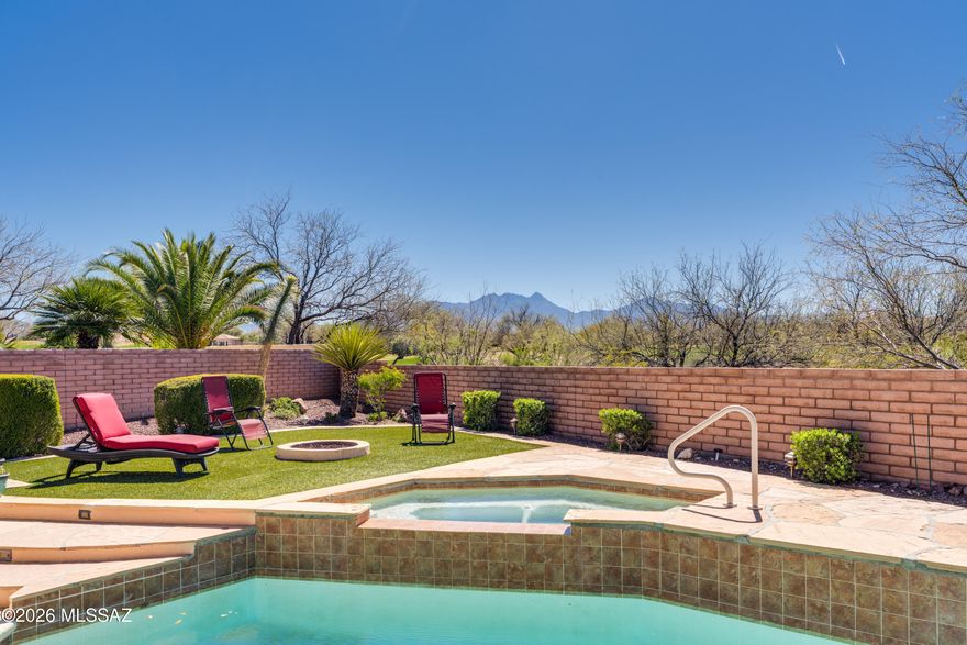 This spacious 3 BR, 2.5 BA Cheyenne model offers 2,793 sq.ft, and the perfect blend of comfort, functionality, and indoor/outdoor living. Featuring a pool, spa, fire pit, mountain views, owned solar, and a separate workshop/studio, this is truly a home that has it all. A well-defined front courtyard and impressive 8' entry door welcome you into the foyer, which opens to formal living and dining rooms, ideal for entertaining. A convenient wet bar connects the formal and informal living spaces, creating great flow for gatherings. The spacious family room features a cozy gas fireplace and media wall, and opens to the kitchen and casual dining area. The chef's kitchen is designed for everyday living and entertaining, showcasing granite counters, gas cooktop, wall oven and microwave, island with breakfast bar and pendant lighting, and a desk for organizing household tasks.The owner's suite includes a bay window, two walk-in closets, and a luxurious bath with dual vanities, jetted tub, and separate tile shower. The split bedroom plan provides privacy with two guest bedrooms, a full guest bath, and a powder room for visitors. A large versatile den/office features built-in desks, bookcases, and a wall bed, making it ideal as a workspace or optional fourth sleeping area. Enjoy outdoor living year-round from the large end-to-end covered screened porch, overlooking a resort-style backyard. Spend warm Arizona days in the heated pool with waterfall and spillover spa, and cool evenings around the gas fire pit, all surrounded by low-maintenance artificial turf and open views of the Santa Rita Mountains with no rear neighbors. The backyard also includes a separate 389 sq.ft.workshop/studio with adjacent storage and loft, perfect for hobbies, projects, fitness, or creative space, plus a BBQ area for outdoor entertaining. The home is equipped with an owned 10 kW solar system, providing energy efficiency and long-term savings. New roof in 2023, and 2 new HVAC units in 2018. A rare Cheyenne model with premium upgrades, privacy, and exceptional outdoor amenities in Quail Creek.