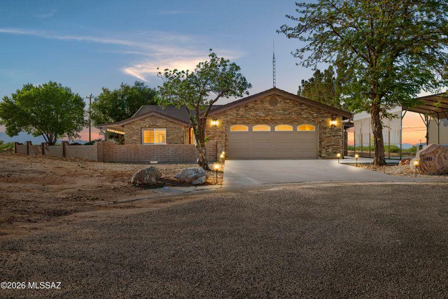 Step into a home where warmth, craftsmanship, and outdoor living come together seamlessly. Natural stone finishes flow throughout the home, complemented by exposed wood beams, plantation shutters, and thoughtful upgrades. The kitchen features granite countertops, stainless steel appliances, a walk-in pantry, and a second pantry for added storage. Designed for comfort and flexibility, the home includes two master suites and a den (approx. 14.5' x 14.5'). The outdoor living space is exceptional, showcasing a covered patio with a stone fireplace, outdoor kitchen with grill and pizza oven, and sweeping views of the Stronghold Mountains. Step into a home where warmth, craftsmanship, and outdoor living come together seamlessly. Natural stone finishes flow throughout the home, complemented by exposed wood beams, plantation shutters, and thoughtful upgrades. The kitchen features granite countertops, stainless steel appliances, a walk-in pantry, and a second pantry for added storage. Designed for comfort and flexibility, the home includes two master suites and a den (approx. 14.5' x 14.5'). The outdoor living space is exceptional, showcasing a covered patio with a stone fireplace, outdoor kitchen with grill and pizza oven, and sweeping views of the Stronghold Mountains.

Additional highlights include a 400 sq ft shop included in the square footage, full concrete RV pad with hookups, block-walled backyard, city water and sewer, natural gas hookup, 24kW generator with 300-gallon owned propane tank, tankless water heater, and extensive outdoor entertaining space--perfect for year-round living and entertaining.
