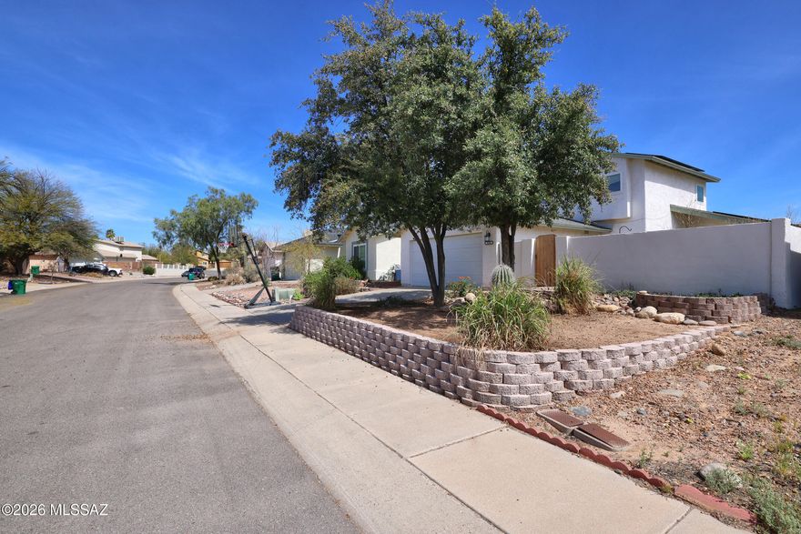 Roomy & beautifully maintained 1495 SF, 4 BR/2BA home features thoughtful upgrades. Fully remodeled kitchen showcases granite counters, updated cabinetry, stainless fridge, flat-top stove and cozy breakfast nook. A convenient pass-thru window connects kitchen to living room. Exceptional privacy with a fully walled yard that includes front courtyard entry. Mature landscaping features mature shrubs, plantings & 2 live oak trees along with 2 outdoor seating areas.  Inside -- newer windows, ceramic & luxury vinyl floors. Primary bedroom conveniently located downstairs with dual vanities & tub/shower combo & updated tile & fixtures. Upstairs offers 3 add'l bedrooms and updated bathroom. Addtional highlights include newer HVAC/Gas-Pac system, security camera system & 2 car garage