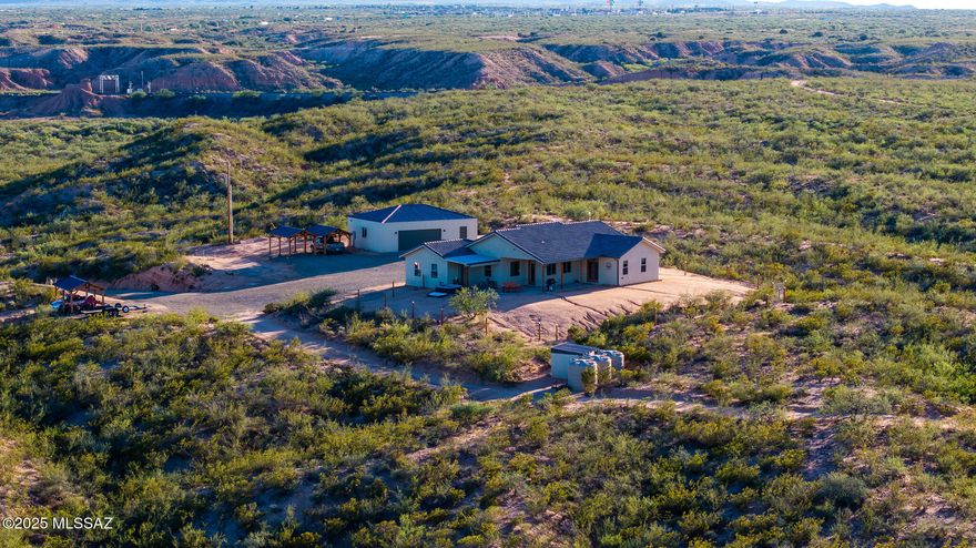 Truly loved steel construction home on 30 acres with unmatched panoramic views + Incredible sunrises AND sunsets! Spray foam insulation keeps the outside at bay while you enjoy your chef's kitchen complete with granite counters, a 48'' gas range and tons of storage. Oversized second bedroom gives you the flexibility for a dual master set-up, a large office space, or an additional living area. A detached, insulated and air conditioned 30x40 shop includes a one bedroom/bath guest quarters. 3 beautiful, wood and steel carports provide shade for cars, toys, equipment, or critters. Add sides and voila...it's a stable! Zoned RU4- Cover the hillsides with vineyards or orchards. Private well is solar powered. 6,000g holding tanks. ENVISION YOUR DREAMS! Call TODAY! This home is a must see!