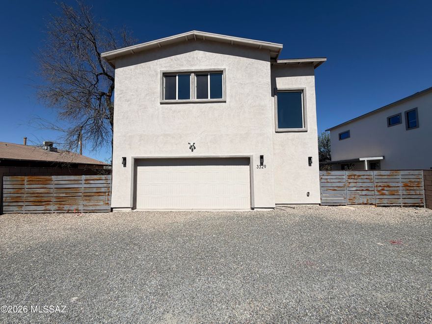 Modern, private, gated 4BR/3.5BA contemporary home featuring high ceilings, mountain views, and wood-plank tile throughout. The open kitchen boasts quartz counters, black stainless appliances, and a large island. Upstairs includes four spacious bedrooms with walk-in closets, two ensuite baths, a laundry room, and a covered deck with panoramic Catalina and Rincon views. Conveniently located near the UofA and downtown.