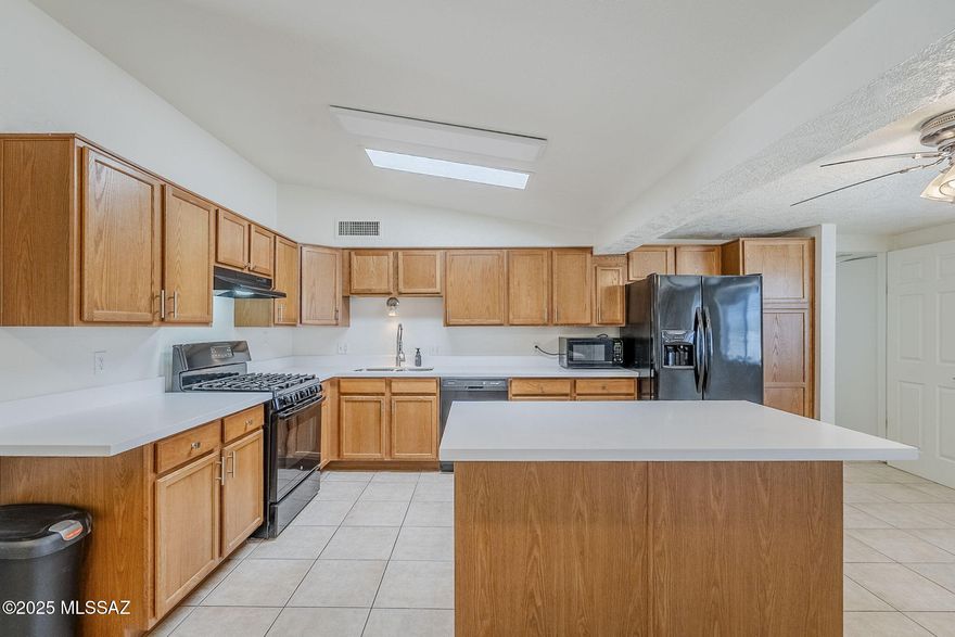 SELLER IS OFFERING CONCESSIONS even after many upgrades just completed. Fresh and lots of room in this warm neighborhood boasting a very large kitchen with lots of cabinets and new quartz countertops. including an island.  Front bedroom off of the living room enjoys a two way fireplace. The home is completely fenced with a slide open gate in front and an entrance off of the alley. Entertaining in your back yard is convenient with your covered carport with cabinets and large slab of granite for those weekend BBQs. Attached is a workshop for all of your projects or storage making this back yard complete. Great affordable home!
