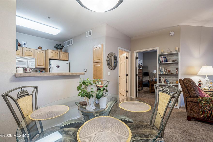 Welcome home to this beautifully furnished and maintained condo in Oro Valley offering comfort, convenience, and a bright open layout. From the inviting front entrance to the spacious living and dining areas, this home features abundant natural light, neutral finishes, and a seamless flow perfect for everyday living or entertaining. The kitchen offers ample cabinet and counter space with an open view into the main living area. One of the closest units to the pool, clubhouse and fitness center.  HVAC new in 2021 and newer carpet with tile also. Convenient walking access to shopping, dining, & outdoor recreational activities. Additionally, the condo is just minutes away from the picturesque hiking trails & parks of the Santa Catalina Mountains. Convenient Covered parking space provided.