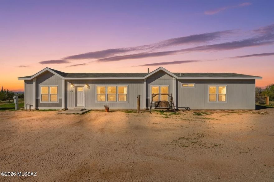 MOTIVATED Seller! 2022 manufactured home on approx 10 acres in rural Pinal County with stunning sunset views including Picacho Peak. Nearly 2,000 sq ft featuring 4 bedrooms, 3 full bathrooms with a Jack and Jill layout, plus a flexible den or office space. Open concept kitchen and living area centered around a large entertainer's island ideal for gatherings, meals, and everyday living. Fenced backyard with artificial turf, chicken coop, and plenty of space for animals, hobbies, toys, RVs, trailers, or equipment. Quiet rural setting with open skies, desert vegetation, and wide open surroundings. Enjoy peaceful desert living, privacy, wildlife sightings, and room to spread out while still having a comfortable modern home and space to relax or entertain under the Arizona sky.