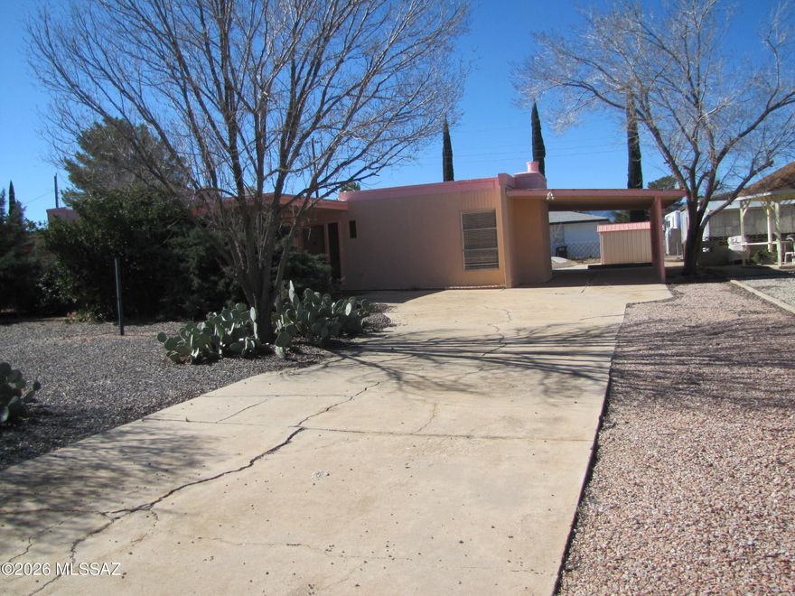 Stucco finish 2BR/2Ba home with den that could be used as third bedroom. Den has sliding door from outside and an outer rock wall. Fireplace in living room and sliding door onto carport. Design your own kitchen - no cabinets or appliances, only a commercial-type sink. Dining area off the kitchen with door leading to back patio with wall around it, only lacking a gate. Backyard has a shed and a blank palette for your landscaping design. Alley behind backyard. Located in Sunsites with its amenities and easy access to Hwy 191 and I-10.