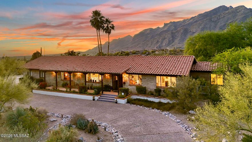 Catalina Foothills View Retreat - Fully Renovated Burnt Adobe Ranch!  Located high on a quiet cul-de-sac in the coveted Catalina Foothills, this classic burnt adobe ranch home captures the essence of Tucson living. Spanning 3,058 sq. ft., the residence offers 4 bedrooms and 3 baths, with breathtaking panoramic city views from the expansive front porch and unobstructed Catalina Mountain vistas from the backyard oasis.  Set among abundant Upper Sonoran Desert vegetation including majestic saguaros, ocotillo, jojoba, desert willows, and agave, the property blends natural beauty with refined comfort.  Beginning in 2015 and extensively renovated over the following year, this home has been thoughtfully reimagined from top to bottom. Major upgrades include: replacement of the original cedar shake roof with durable cement mission tile; fully updated electrical and plumbing systems; completely remodeled kitchen with repositioned island and updated appliances (including a recently replaced refrigerator); renovated bathrooms, plus the addition of a spacious primary bath; newer and updated HVAC systems, including a newer east unit and heat pump; raised ceilings in select areas and added storage space; custom cantera fireplace and hearth in the family room; custom hardwood entry door with seeded glass sidelights and upgraded security door; California Closets-designed storage solutions; updated garage door and system; a separate water heater serves the primary suite for added comfort.  Outdoor living shines just as brightly. The pool and patio area were redesigned to create a private retreat, complemented by lush landscaping, irrigation upgrades, and fragrant star jasmine vines that attract nesting finches year after year.  Meticulously maintained with annual termite inspections and comprehensive documentation for all improvements, this home reflects pride of ownership throughout.  From unforgettable sunrises to peaceful evenings under the stars, this is a place where lasting memories are made. Now ready for its next chapter, this exceptional property offers a rare opportunity to own a truly turnkey home in one of Tucson's most desirable settings, and in the Catalina Foothills School District #16.