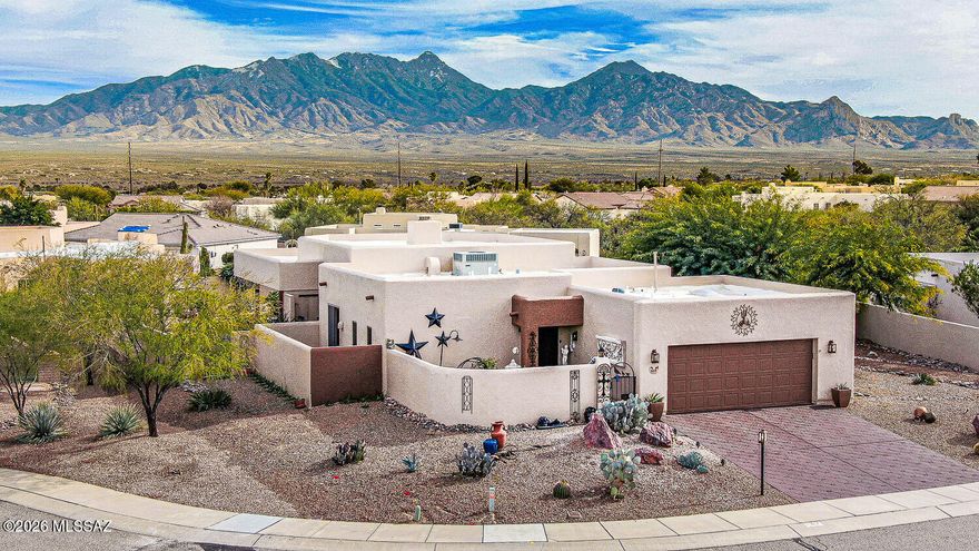 Spectacular mountain views define this highly desireable home, ideally situated at the end of a quiet cul-de-sac.   Step inside to a welcoming elongated hallway that leads to a striking double-sided fireplace, seamlessly connecting the kitchen on one side and a cozy TV room on the other.   Beyond, the formal living room is framed by floor-to-ceiling windows, flooding the space with natural light and perfectly capturing the breathtaking mountain vistas.  Outdoor living is just as impressive, featuring a side bar area, ideal for entertaining and spacious covered back patio designed for exquisite indoor-outdoor living.   A tranquil fountain adds soothing water sounds, creating a peaceful retreat perfect for relaxing or hosting guests. Some furniture available by SBOF.