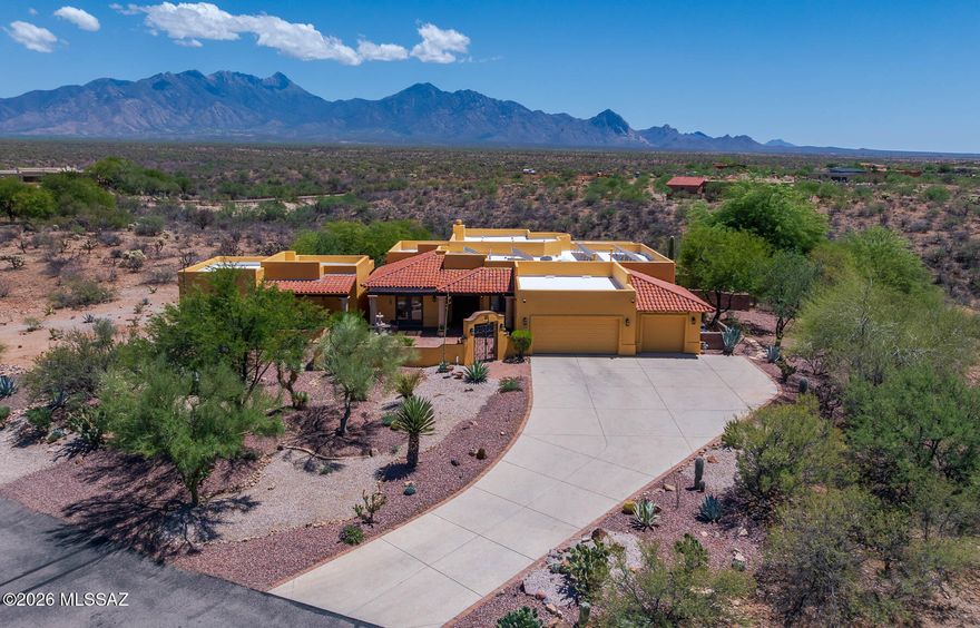 Stunning views, striking architecture, and a resort-style backyard define this Hacienda Gold Territorial custom home in the gated community of Madera Shadows. Set on 1.6+ acres, it features a welcoming courtyard and private NextGen casita--ideal for guests or multigenerational living. The split floorplan offers 3 bedrooms and 2.5 baths, including a spacious primary suite with a luxurious bath and large walk-in closet. The gourmet kitchen showcases oak cabinetry, granite countertops, stainless appliances, gas cooktop, electric oven, and walk-in pantry. Panoramic windows capture breathtaking views of Mt. Wrightson and the Santa Rita Mountains. Enjoy both a casual dining nook and formal dining room. The open great room features a stunning rock fireplace, perfect for relaxing or entertaining