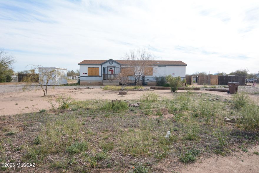 Manufactured Home is in need of TLC and will be sold in AS-IS condition. Fixer upper, 4 bedroom, 2 bath home. On approximately 1 acre. The fenced backyard offers privacy and room to create your own outdoor retreat. Situated in a quiet neighborhood.