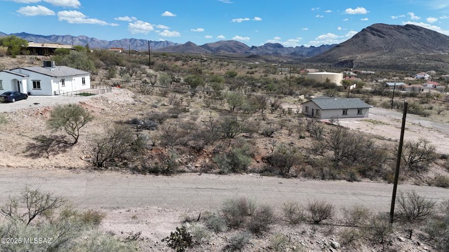 Residential lot with slightly raised location.  Paved access, electric, water and sewer at the street.
