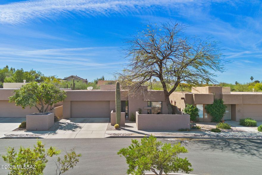 Welcome to 137 S Shadow Creek Place in Broadway Court, a small enclave of architectural homes, conveniently located to access city amenities and open spaces. Designed by the well-known architect David Tyson, this home showcases clean lines, well placed windows and thoughtful design throughout. Situated with open space and greenery behind, the property feels tucked away. Inside the 2,040 sq ft residence, you will find dual living spaces, 4 bedrooms and 2 full bathrooms. Anchoring the living room and entry, an offset gas fireplace is complemented by a large window with views of the Catalina Mountains. Touches of Saltillo tile bring in a bit of Southwest flair, while being balanced by more modern elements. Spaces feel warm, inviting and comfortable. The primary suite has private access to the outdoors, a walk-in closet, and a generous ensuite bath finished with travertine, a soaking tub and walk-in shower. 

Outside, the covered patio is an extension of the living space, which feels cocooned by vegetation. The feeling is one of privacy and calm. Raised beds and trellis work provide a blank canvas for future gardens. 

Behind the home, open space leads to a path that connects to Case Natural Resource Park, which offers seating areas, a playground, a hummingbird and butterfly sanctuary, large grassy areas and space to explore. Within walking distance, there are several grocery stores, dining, a movie theater, banking and other services. While the setting is urban, residents have the Rincon Mountains at their fingertips - in just 7 minutes, the Broadway trailhead leads to abundant trail systems for outdoor recreation.