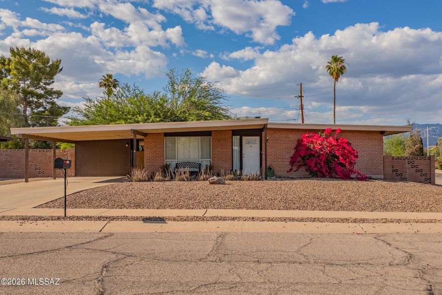 Charming East Side Tucson home on a spacious corner lot with classic Southwestern character and mountain views. This well-maintained single-story brick residence features bright living spaces, large picture windows, neutral finishes, and a comfortable layout designed for everyday living. The expansive living room flows into the dining area and kitchen, while generously sized bedrooms provide flexibility for guests or a home office. Step outside to enjoy the oversized backyard with mature shade trees, decorative block walls, and a covered patio perfect for relaxing or entertaining year-round. Conveniently located near shopping, dining, parks, and everyday amenities, this home offers comfort, privacy, and endless potential in a desirable Tucson neighborhood.