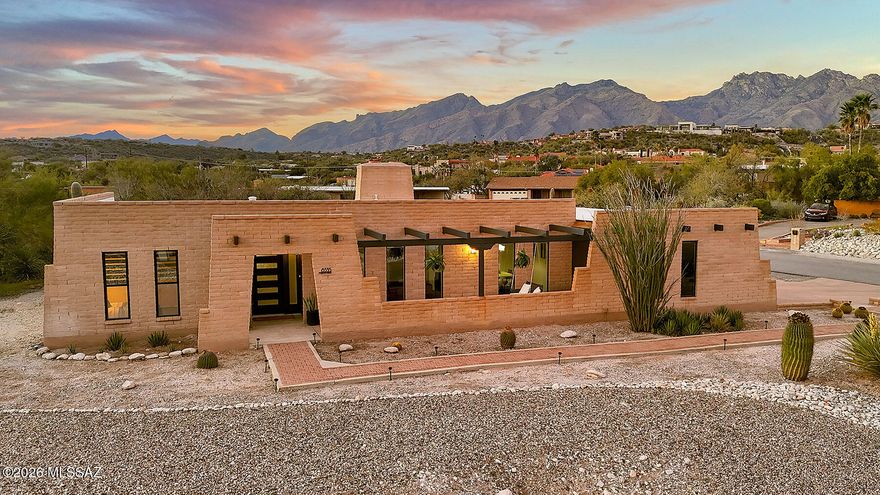 Beautifully designed home on a hill with both city & mountain views!  Two spacious living areas - each with it's own fireplace - dining room & eat-in kitchen provide plenty of space for hosting & everyday living!  Exterior accordian 12' doors open up onto a large 500 sq ft porch for indoor/outdoor living.  Kitchen features white oak cabinets with pull out shelving, pantry cabinet, microwave cabinet & pull-out trash AND new appliances.  Plenty of storage in the laundry/mudroom-TWO master closets-exterior storage room, garage & shed!  Low maintenance desert landscaping in both front & back.  Extra space behind the back yard wall - over ½ acre lot!  Come see your new home today!