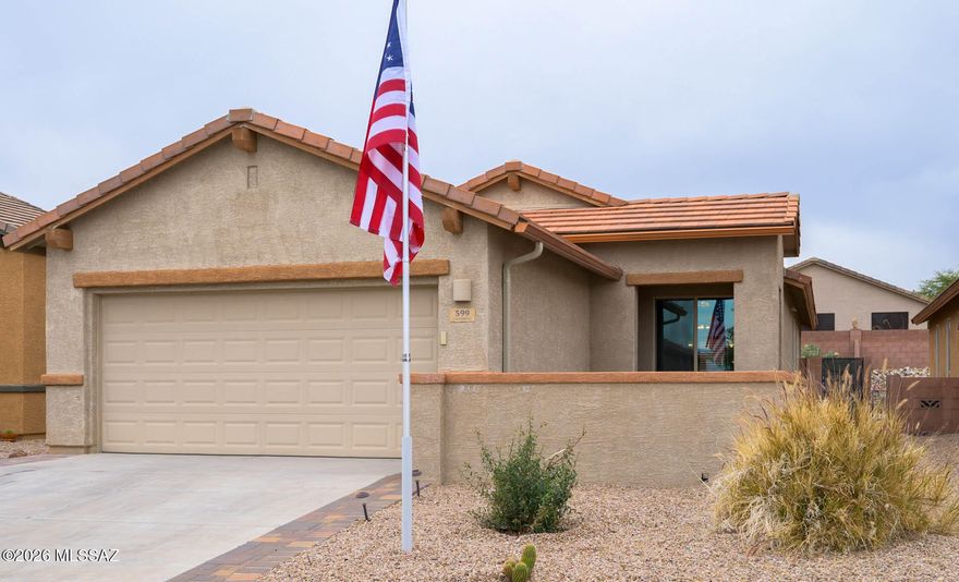 Terrific 2 bedroom, den single family home in one of Green Valley's most desirable neighborhoods, Las Campanas. Low HOA with county maintained streets, fantastic recreation center, nearby walking trails and centrally located west of Interstate 19 away from major streets. Tucked on a side street, this home provides convenience, privacy and affordability. Engineered pine wood flooring flows throughout the great room and den leading to a quiet backyard with maintenance-free artificial turf surrounding a putting green. Solar screens on the rear patio minimize sun exposure while the front courtyard also offers a cool, shaded afternoon alternative. Upgraded maple cabinets, granite counters and a contemporary silver accented gray subway tile backsplash highlight a chef's kitchen of sleek, black appliances including a gas range. The plush carpeted primary bedroom suite has an office, sitting area as well as sufficient space for a king-size bed, nightstands and dresser. Both bathrooms feature executive height vanities and newer dual flush toilets. The well-designed floorplan maximizes the efficient use of 1431sf.