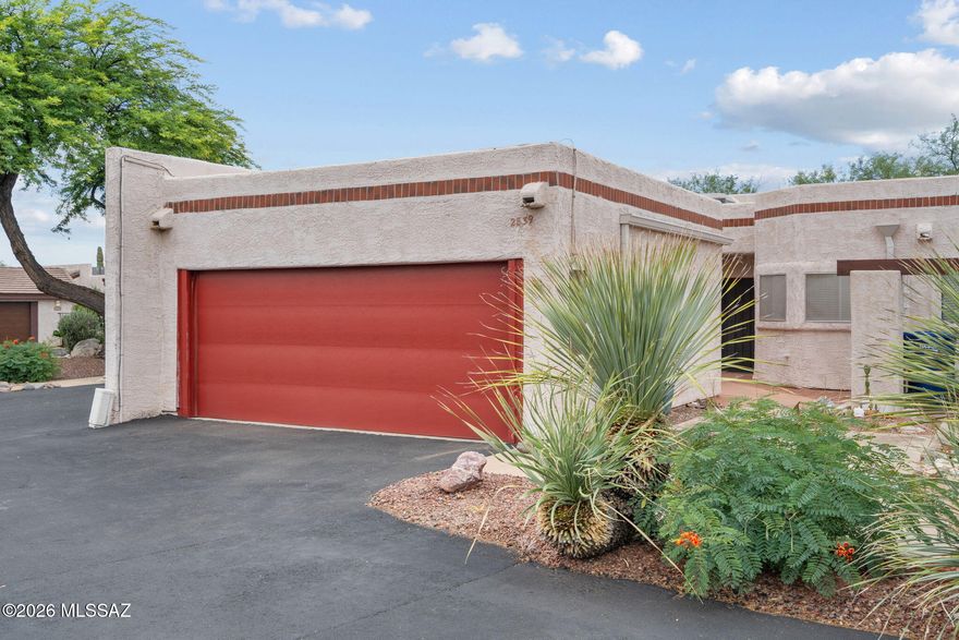 Experience effortless style in this beautifully maintained townhome within a private gated community. The open floor plan and soaring ceilings create an expansive atmosphere enhanced by natural light. French doors that highlight the sleek polished concrete floors. At the heart of the home, a wrap-around kitchen features granite countertops, stainless steel appliances, and a custom eat-in table overlooking the large living area. Practicality meets luxury with two spacious walk-in closets, an oversized two-car garage, and a private covered patio with low-maintenance landscaping. Perfectly situated for an active lifestyle, you are just moments from the Tucson Racquet Club, The Loop, downtown, and the U of A. This is modern central living at its finest.