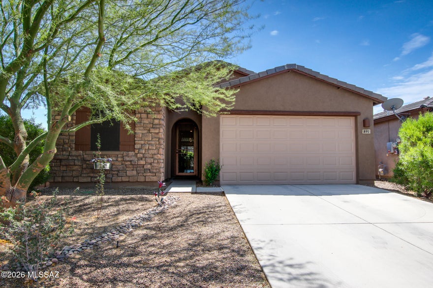 Better than new and packed with value! This stunning, well-cared-for 3 bed, 2 bath home sits on a prime corner lot just steps from the Safari Park and features owned solar, a striking custom wrought iron front security door, and a spacious 3-car tandem garage. Inside, you'll love the tall ceilings and bright, open-concept kitchen, living, and dining areas--perfect for entertaining. The split floor plan offers privacy, while the primary suite impresses with a relaxing sitting area and a gorgeous walk-in tile shower. The fully landscaped backyard is ready for your enjoyment--relax and take in the beauty of the pollinator garden while lounging under the extended patio, complete with an electric privacy panel.