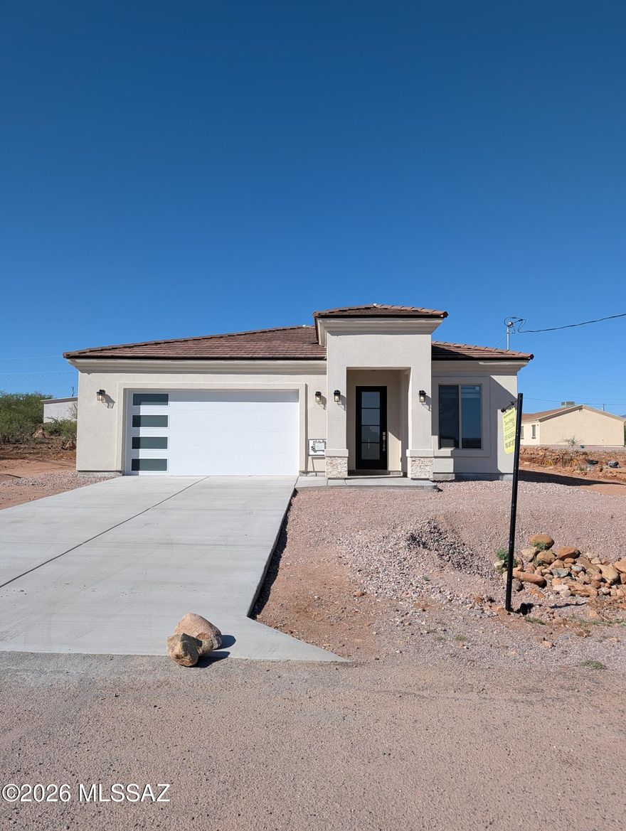 Owner / Agent - Enjoy beautiful mountain views from this stunning new home in Rio Rico! This single-story three bedroom, two bath home offers 1,639 sq ft with an open-concept layout, tile throughout, and blinds already installed. The upgraded kitchen shines with gorgeous waterfall granite countertops, stainless steel appliances, and a spacious design that opens to the main living area. Beautifully finished bathrooms add a custom touch, while the long extended driveway offers extra convenience and curb appeal. Stylish, functional, and surrounded by scenic views, this Rio Rico home is ready to impress.