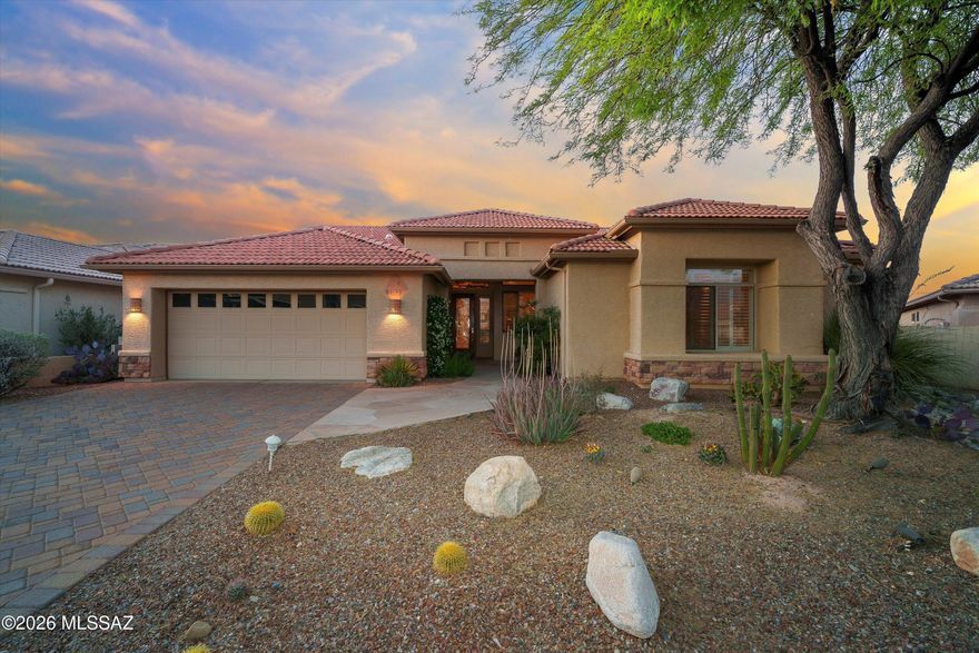 Tucked inside the highly sought-after SaddleBrooke community, this beautifully maintained home offers peaceful desert living with stunning mountain views from the backyard. The inviting curb appeal features mature desert landscaping, a paver driveway, and a welcoming covered entry. Inside, tall ceilings and abundant natural light create a spacious feel. The open living area includes large windows, plantation shutters, and custom built-in shelving. The kitchen offers generous cabinetry, ample counter space, a center island, and a built-in workspace. Step outside to enjoy the covered patio and overlooking a private desert backyard made for taking in Arizona's beautiful sunsets. Located in SaddleBrooke, known for its golf, pools, fitness centers, dining, and active living