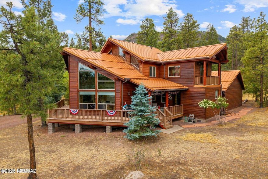 Turnkey Forest Estate | Backs National Forest | Alpine Forest Estates Now Offered at a Newly Adjusted Price Welcome to an exceptional fully furnished custom estate nestled at the base of South Mountain in coveted Alpine Forest Estates. Backing directly to the pristine Apache-Sitgreaves National Forest, this rare offering delivers unmatched privacy, protected views, and immediate access to hiking, wildlife, and year-round recreation. Now available at a thoughtfully adjusted price, this remarkable property presents an extraordinary opportunity to secure a premier Alpine retreat with enhanced value. Spanning 2,353 square feet, the thoughtfully designed multi-generational floor plan offers 4 bedrooms, 3 full bathrooms, and multiple living areas ideal for extended family, holiday gatherings, and entertaining.
The main level showcases a serene primary suite with spa-style bath, an additional guest bedroom and full bath, and a dramatic great room featuring floor-to-ceiling windows, knotty alder cabinetry, granite countertops, custom tile work, and a warm gas fireplace.
Upstairs, two oversized bedrooms (one large enough to serve as a game room), a loft, dedicated office space, and private balconies with French doors invite you to enjoy crisp mountain mornings and cool alpine evenings.
Outdoor living is equally impressive with a 1.5-Trex wraparound covered deck designed for peaceful mornings, summer barbecues, and wildlife viewing.
Exceptional infrastructure and upgrades include:
" Fully finished 3-car detached garage with cabinetry, workbench & Rinnai heater
" Covered breezeway connection
" Generac automatic-start generator
" 1,000-gallon in-ground propane tank
" Rinnai tankless water heater
" Amana dual-zone A/C
" ADA-friendly wide hallways and doors
" Game-ready backyard with concrete recreation pad & gas BBQ stub
" Mudroom with Kohler sink; washer & dryer included
This home is truly turnkey!! just bring your personal belongings. Ideal for year-round living or seasonal retreat ownership.

Located just 40 minutes from Sunrise Park Resort, Alpine offers four-season recreation including world-class hunting, fishing, lakes, rivers, and mountain trails.
With pride of ownership evident throughout and every detail already in place, this forest-backed estate is ready to become your family's legacy retreat. Now with compelling new pricing.