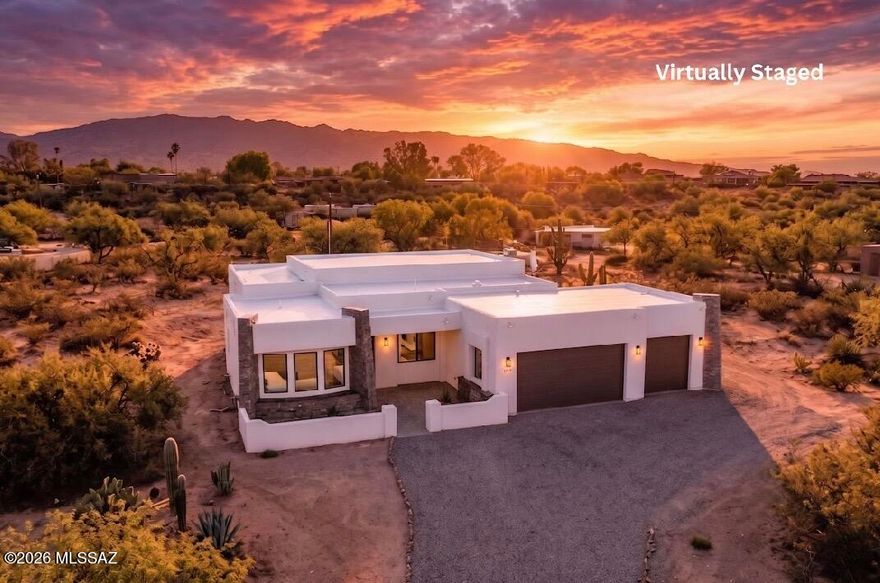 Price Drop! Price Ranged-Set against the dramatic backdrop of the Catalina Mountains, this New Construction desert luxury home in Tucson is nestled within the exclusive enclave of San Domingo Estates, offering privacy, breathtaking scenery, and refined Southwestern living. A long, private driveway welcomes you to this custom-built residence, where stone-accented architecture, a three-car garage, and a beautifully designed courtyard entry with pavers set the tone for the home's thoughtful craftsmanship. The courtyard provides the perfect setting for morning coffee or evening relaxation while taking in the spectacular Catalina Mountain views that define Tucson's sought-after desert landscape. Inside, this stunning 3-bedroom, 3-bath luxury residence showcases soaring ceilings, expansive.. windows and an open-concept floor plan filled with natural light. The formal dining space features elegant recessed lighting, creating an ideal setting for both intimate gatherings and larger entertaining. Throughout the home, custom Spanish-style concrete floors evoke the timeless character of the Southwest, while exposed wood beam ceilings add warmth and architectural sophistication. The seamless blend of rustic desert charm and modern luxury creates an inviting yet elevated atmosphere.       At the heart of the home, the chef's kitchen is designed for both functionality and style, featuring a grand granite island, custom cabinetry, granite countertops, and a beautifully crafted tile backsplash. This space flows effortlessly into the main living area, where a striking centerpiece fireplace creates a warm focal point and enhances the home's welcoming ambiance. The primary suite is a private retreat, thoughtfully designed with luxury finishes, a spa-inspired soaking tub, walk-in shower, and an expansive walk-in closet. Outdoor living is equally exceptional. An extended covered patio with exposed beams and a modern metal roof offers the perfect space to unwind, entertain, and enjoy Tucson's year-round sunshine and breathtaking mountain views. The generous backyard offers a blank canvas for your future outdoor oasis--ideal for adding a custom pool, spa, or resort-style entertaining area to complete your Tucson desert luxury lifestyle. Additional highlights include a spacious three-car garage with room for storage, a workshop, home gym, or recreational vehicles. With no HOA and RV access, this property provides rare flexibility while maintaining an upscale setting. Perfectly positioned for those seeking new construction in Tucson with Catalina Mountain views, this exceptional residence delivers the ideal balance of privacy, luxury, and authentic Arizona desert living. Don't forget to watch Drone Video!