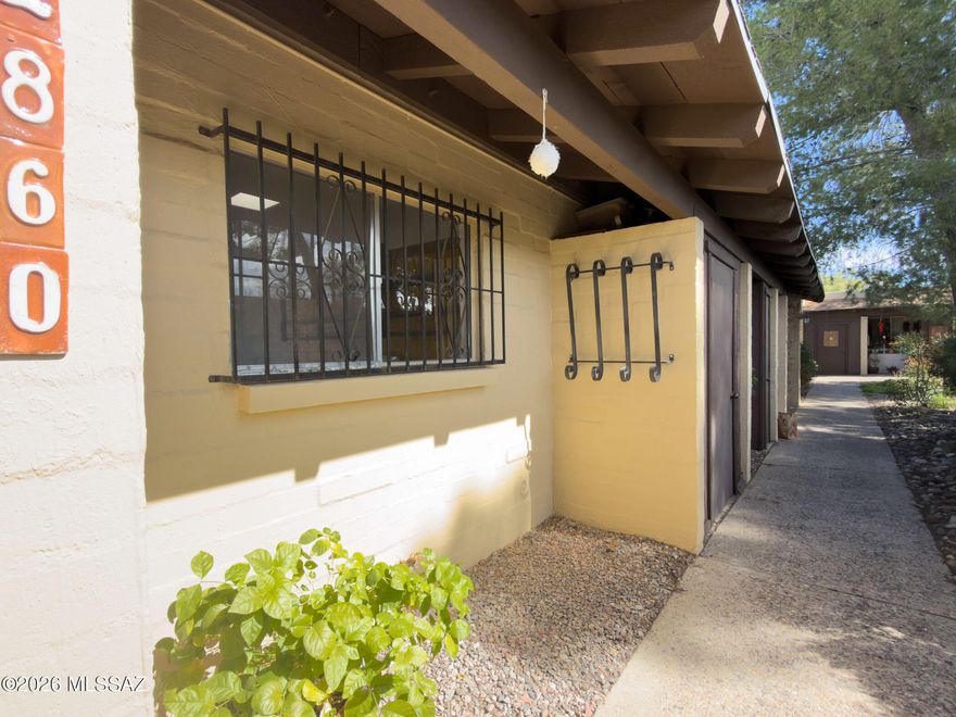 Located in the Fort Lowell Historical District. Close proximity to unique shops and services. You have the option to join a neighborhood program (OFLAH) that enable residents to continue living independently and remain part of the community. An updated property with Marmolearn laminated flooring throughout. New water heater. Recently purchase refrigerator, electric range, washing machine, garbage disposal. Custom handcrafted shelving and counter tops in kitchen. Well maintained roof. Lifetime warranty sliding patio door that leads to beautiful well-planned rear yard with all irrigated native plants. Enjoy the wonderful view of the Catalina Mts on your loverly custom patio deck. HOA fee includes water, trash, recycle and pest control. Current   owner made this a clean turned key property.